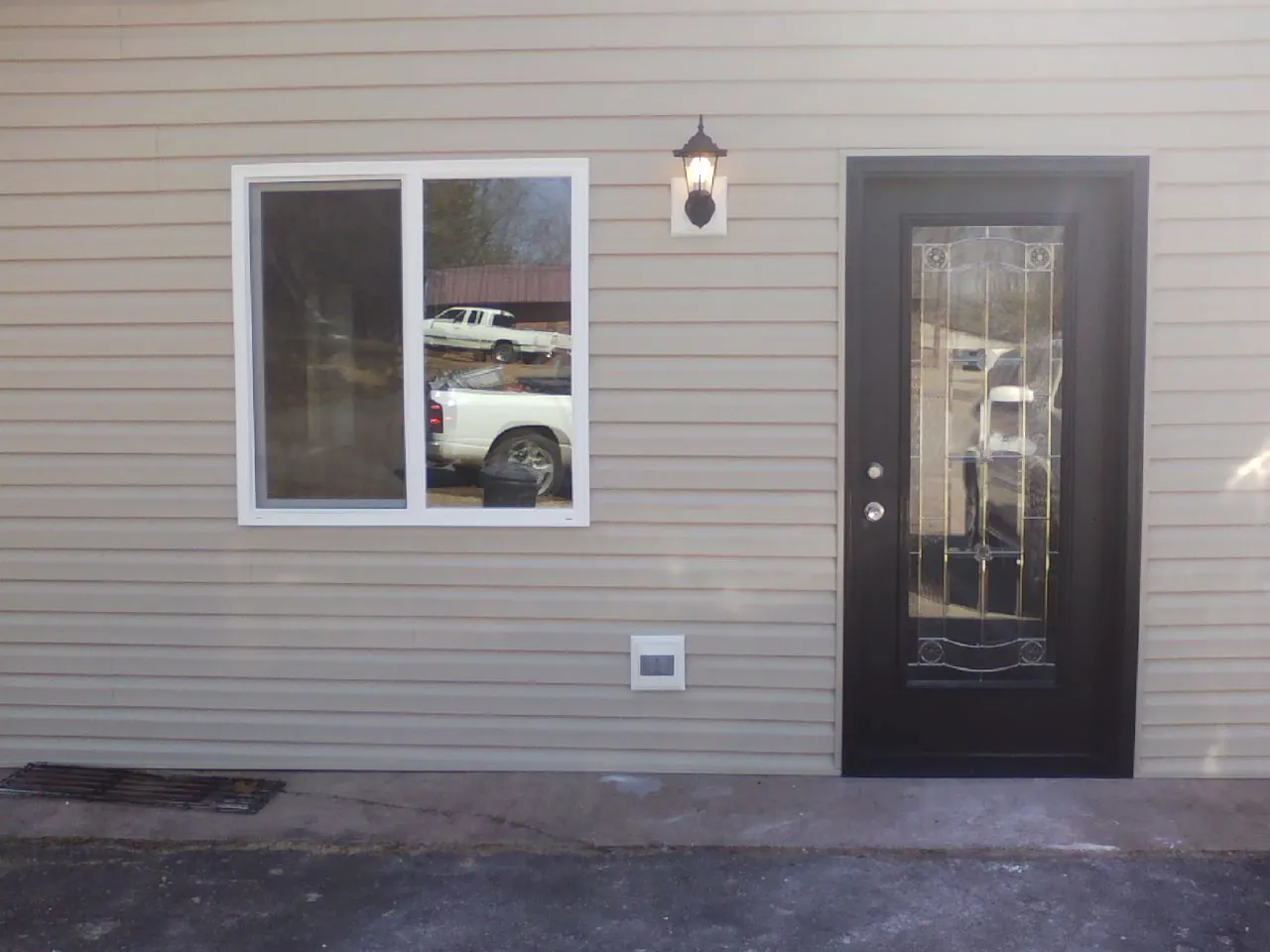 New siding, window and entry door on the side of an addition in Dayton